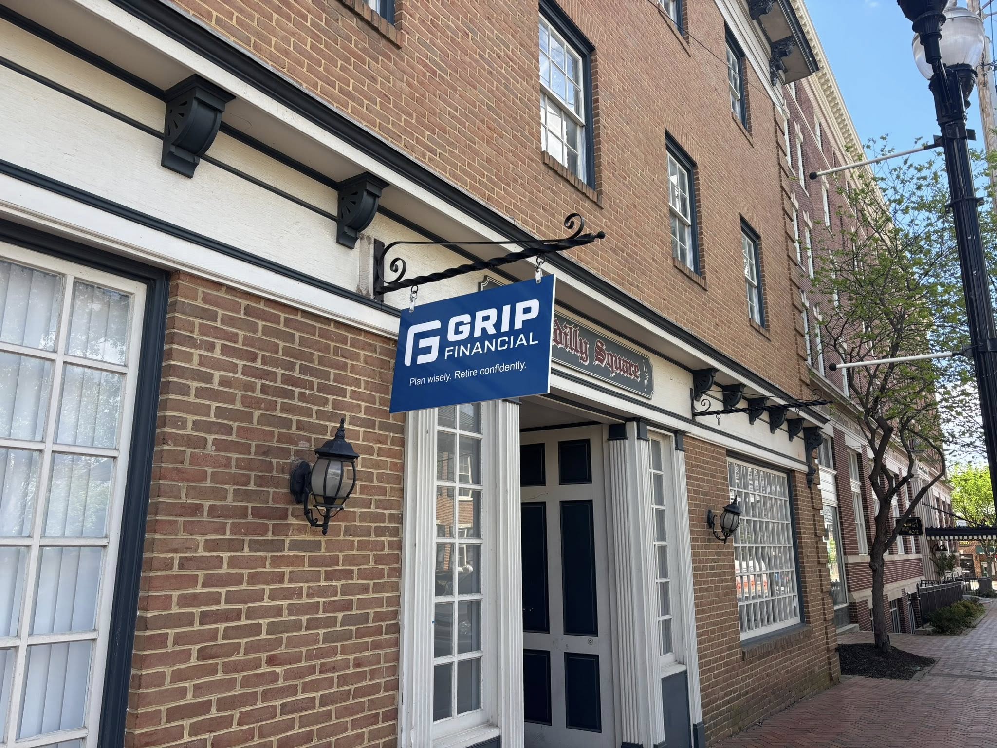 Grip Financial storefront blade sign on historic downtown Winchester building